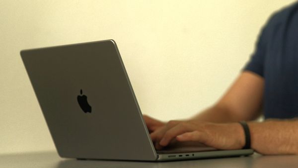 person typing on Apple MacBook Pro 14-inch with M1 Pro chip